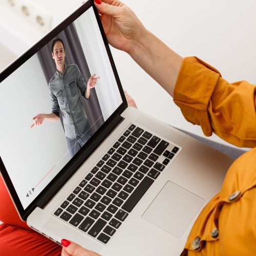 Close-up Of Businesswoman Video Conferencing With Colleague On Laptop